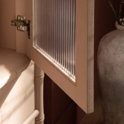 Elstowe Faux Bamboo And Fluted Glass 2-Door Cabinet, Nude Pink 24 Elstowe Faux Bamboo And Fluted Glass 2-Door Cabinet, Nude Pink -Daals XXCAB 069 NUDE scene7